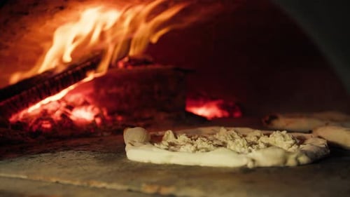 Pizza Preparation in a Rustic Wood Fire Oven