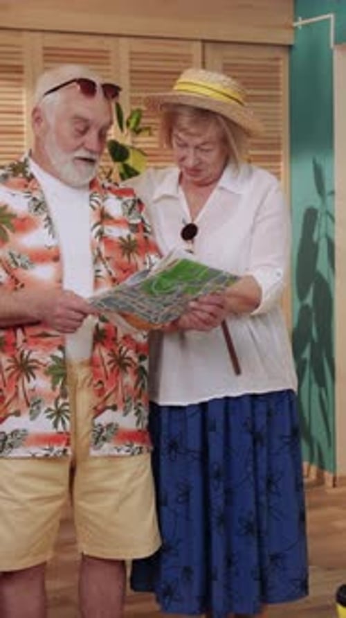 Senior Couple Planning Vacation with Travel Map