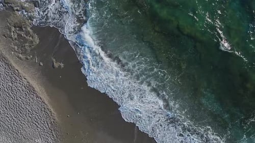 Aerial Video of a Majestic Beach With Azure Waters and a Textured Shoreline Formed By the Movement