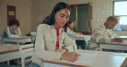 High school, girl and writing in exam for scholarship, thinking and ideas in classroom
