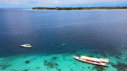 Panorama Of The Boats At The Blue Ocean Of Bali Sea With A Distant View Of An Island. aerial