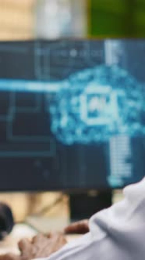 Vertical Video Technician in Wheelchair Using AI on Computer to Optimize Performance