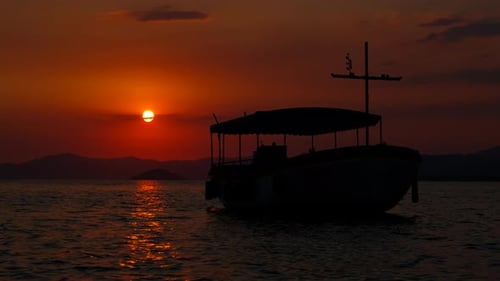 Sunset Silhouette: Boat on the Ocean