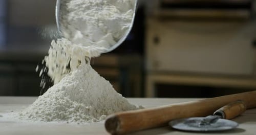 Flour Pouring onto Wooden Table for Baking