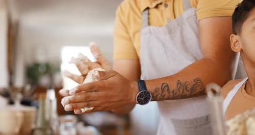 Adult and Child Cooking and Kneading Dough Together