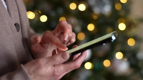 Closeup Side View of Unrecognizable Joyful Woman in Room Tapping and Texting on Smartphone Wishing