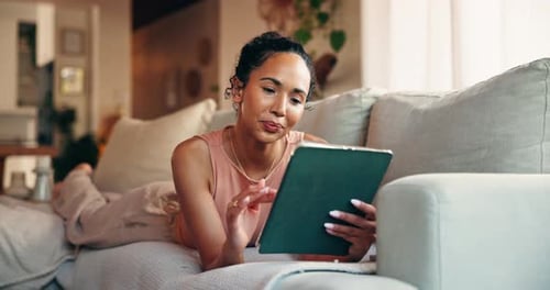 Relaxed Woman Using Tablet Lying on Cozy Couch
