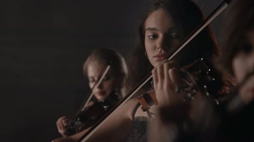 String Trio Plays Violins on Dark Stage