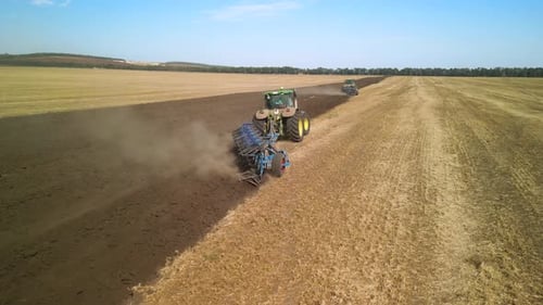 Tractors plowing the field in Ukraine