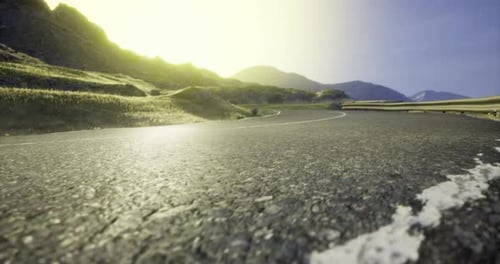 Scenic Winding Road Through Mountains at Sunset Near Coastal Landscape