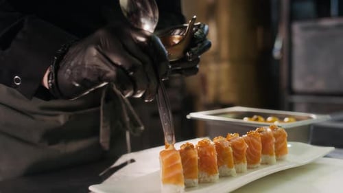 Chef Prepares Sushi with Salmon and Caviar
