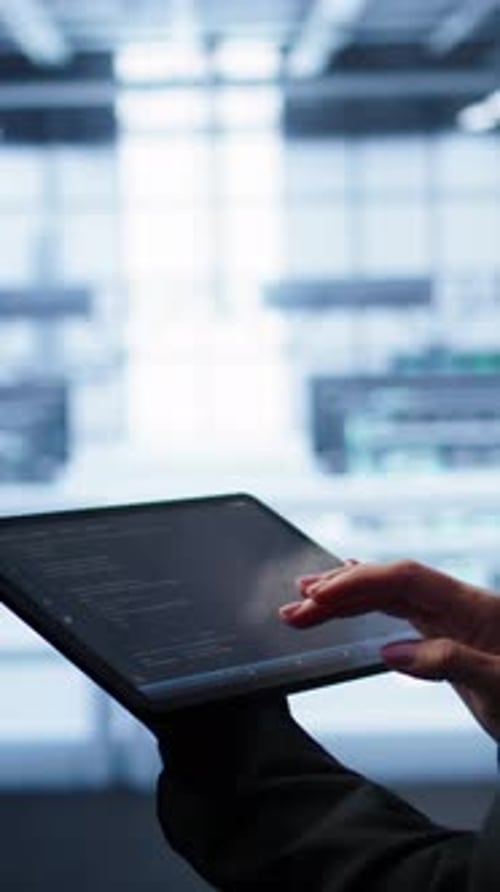 Vertical Video System Administrator Doing Annual Server Hub Checkup Using Tablet