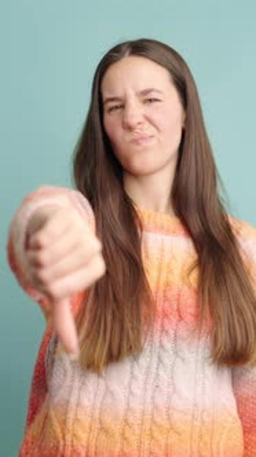 Young Woman Giving Thumbs Down Gesture