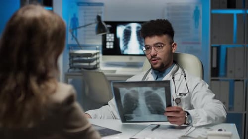 Doctor Explains X-Ray to Patient in Clinic