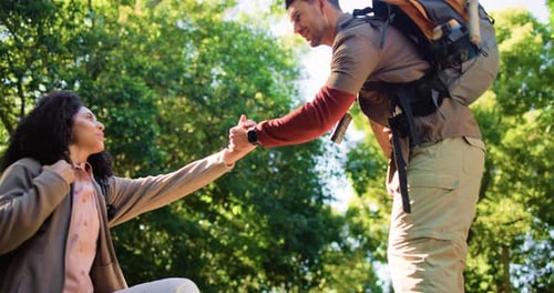 Help, hiking and couple outdoor in nature with backpack, trekking and support for travel low angle