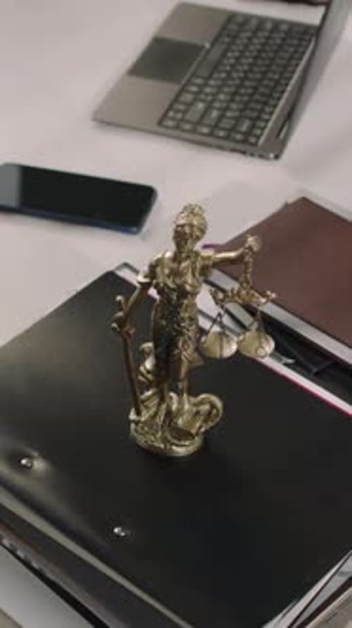 Vertical of Lawyers Office Table with Folders and Themis Figurine