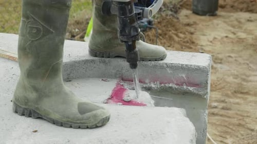male worker builder uses electric impact drill in slow motion