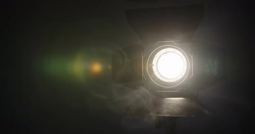 Close Up View of Professional Light Source Yellow Color for Filming Sunlight in Dark Room with Smoke