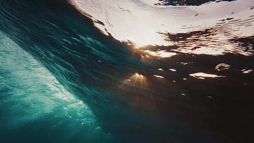 Underwater view of the ocean wave breaking over the shore in the Maldives