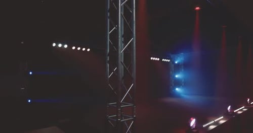 Stage Lights Illuminate an Empty Performance Area Before a Show in Evening