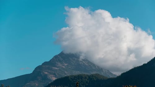 White Clouds Forming Over Mountain Peak