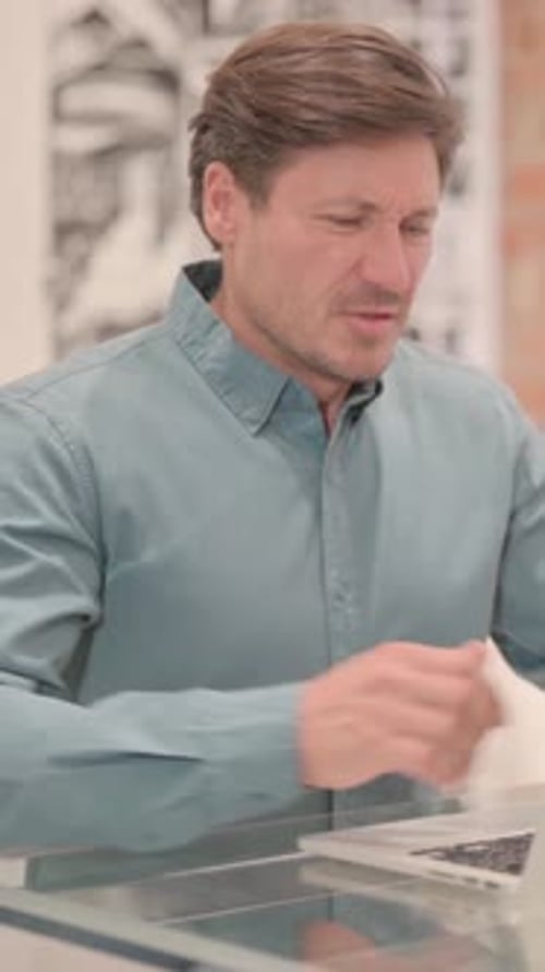 Man Working at Desk Has Back Pain