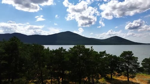 Lake Among Mountains And Pine Forest. The Calm Of Nature