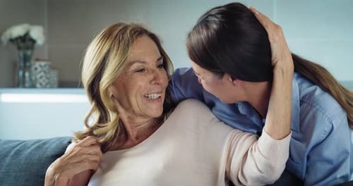 Affectionate Women Laughing Together at Home