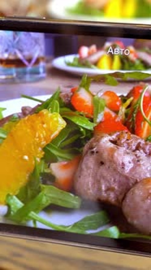 Delicious salad with meat, strawberries and orange