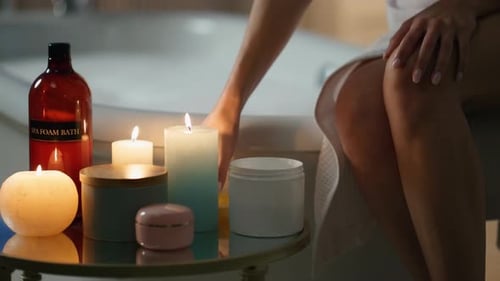Woman Applying Lotion After Luxurious Bath at Night