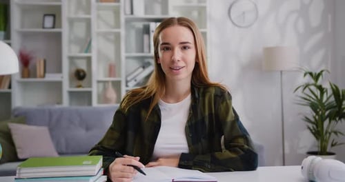 Woman freelancer using modern laptop for distance work. Girl school college student looking smiling