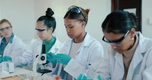 University, science and students in laboratory with microscope for learning, lesson and practical
