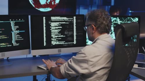 Programmer Writing Codes on Computer