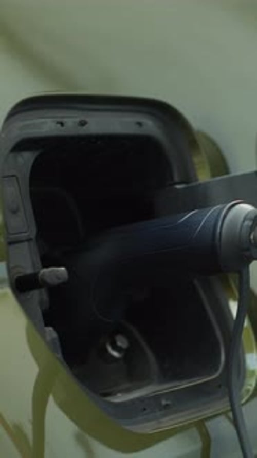 Vertical Video Closeup of Zero Emission EV Vehicle Connected to Charging Dock