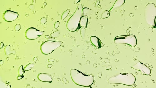 Transparent Green Cosmetic Gel Fluid With Molecule Bubbles and Oil on White Background