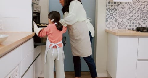 Kitchen, oven and baking family child, mother or people put cookie tray