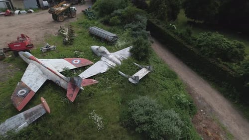 Aerial shot of the De Havilland Vampire and F.6 Hawker Hunter standing on the English farm field
