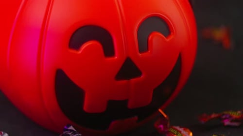 Close up shot of Halloween Pumpkin candy and thunder lights