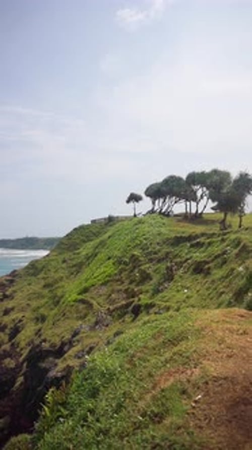 beautiful vertical video stretch of beach with blue sea water with big waves during the day