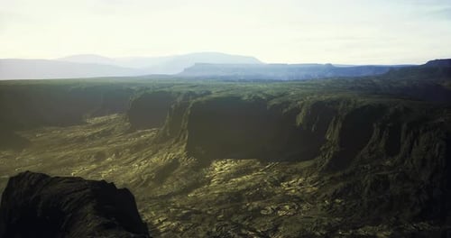 Majestic Mountain Landscape with Deep Valleys and Sunlight at Dawn