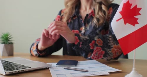 Woman Types on Laptop then Presents Passport