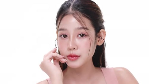 Close up portrait beautiful young Asian woman with healthy facial skin over white background.