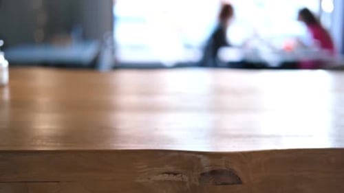Empty Wooden Table and Blurred Background of City Restaurant Coffee Shop for Display of Montage