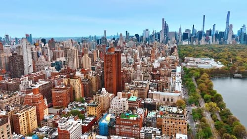 Scenic view of New York with green park and pond. Skyscrapers skyline at backdrop. Top view.