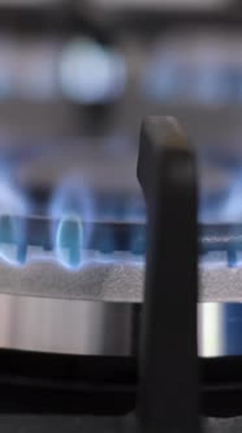 Lighting a Fire on a Kitchen Gas Stove A Closeup of the Burning Flame of the Burner Vertical Video