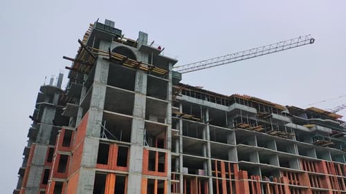 Construction of high-rise building. Front view of huge building in the process of construction.
