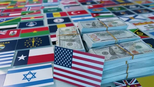 US Currency Stacked on World Flags Background