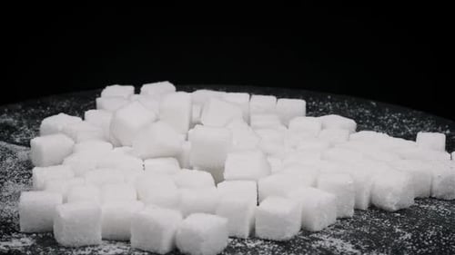 Pile of Sugar Cubes Rotate on a Black Background CloseUp