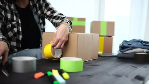 Girl Packing Packing A Cardboard Box For Shipping