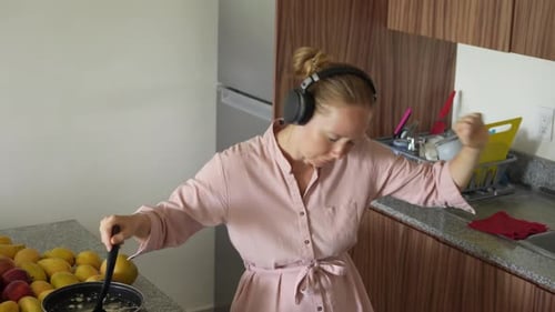 Woman Dances While Cooking with Headphones On